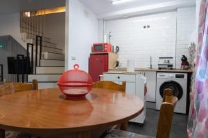 a kitchen with a wooden table with a red bowl on it at Casa Loma Manolo in Molinaseca