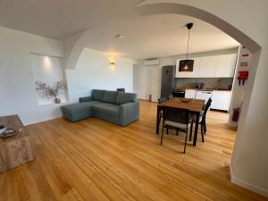 a living room with a blue couch and a table at Blue Whale Appartment in Horta