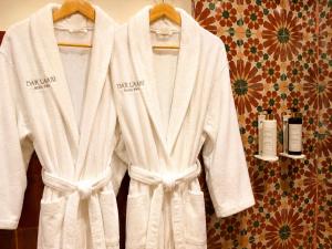 a white robe is hanging on a wall at Dar Laabi - Riad Aya in Fez +62 photos