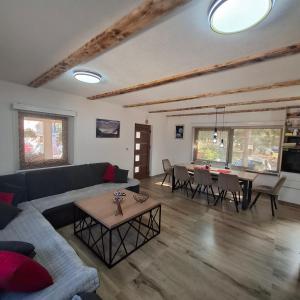 a living room with a couch and a table at Planinska kuća Aurahill-Blidinje in Blidinje