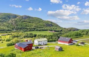 an aerial view of a farm with mountains in the background at Midtigården in Teksdal