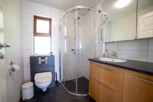 a bathroom with a shower and a toilet and a sink at Hali Country Hotel in Gerdi +51 photos