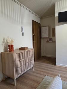 a living room with a wooden table and a door at L'Empreinte in Cahors