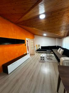 a large living room with a large bed and a table at Drini river view in Shkodër