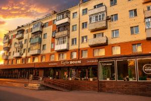 a large building with a store in front of it at Студия Назарбаева 57 in Kokshetau