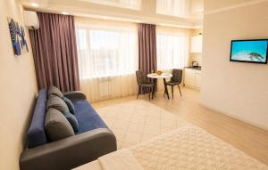 a living room with a couch and a table at Студия Назарбаева 57 in Kokshetau
