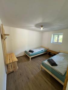 a room with two beds and a table at Chata Borůvka in Pec pod Sněžkou