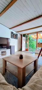 a living room with a wooden table in a room at GADD Ferienwohnung 004 Glück an der Donau I Best Prestige Stay 24 h Check-In in Straubing