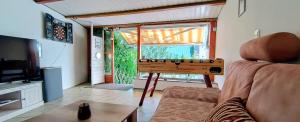 a living room with a table in front of a window at GADD Ferienwohnung 004 Glück an der Donau I Best Prestige Stay 24 h Check-In in Straubing