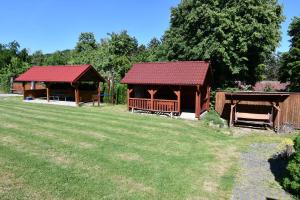 two gazebos in a yard with a grass field at Penzión Hôrka in Vinné