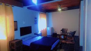 a bedroom with a bed and a tv in it at Happy Time guest house in Phalaborwa