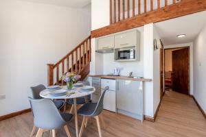 a kitchen and dining room with a table and chairs at Kent Coast Stays - Cottages in Birchington