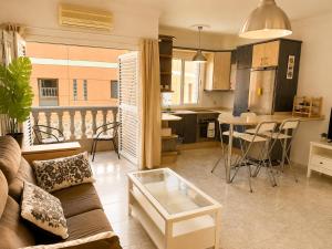 a living room with a couch and a table at Roca Mogán in Puerto de Mogán