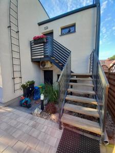 a staircase leading up to a house with a balcony at Apartament Laura in Mechelinki