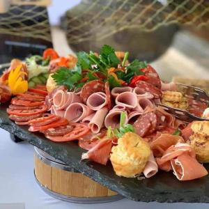 a plate of food with meat and vegetables on a table at Olopiro Stay in Maasai Mara National Reserve
