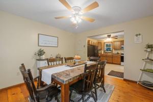 a dining room and kitchen with a table and a ceiling fan at Dog-Friendly Retreat, Fire Pit, Lakes Region in Gilmanton