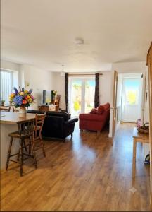 a living room with a couch and a table at Sammy's place in Hayle