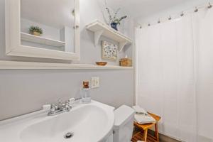 a white bathroom with a sink and a shower at Dog-Friendly Retreat, Fire Pit, Lakes Region in Gilmanton +42 photos