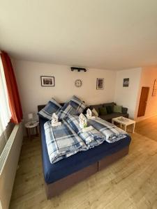 a bedroom with a bed with pillows and a couch at Ferienwohnung Talblick in Sankt Englmar