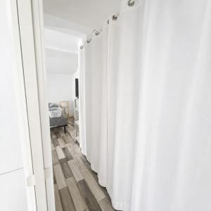 a row of white curtains in a room at Pollart in Les Arcs sur Argens +3 photos