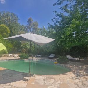 an umbrella sitting in a swimming pool at Pollart in Les Arcs sur Argens