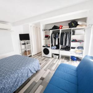 a bedroom with a bed and a blue couch at Pollart in Les Arcs sur Argens