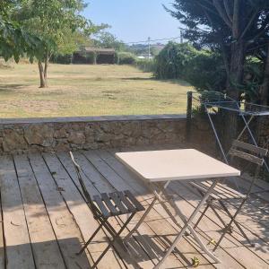 a table and a chair sitting on a wooden deck at Pollart in Les Arcs sur Argens
