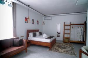 a bedroom with a bed and a couch at Pemba Paradise in Makangale +21 photos
