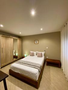 a bedroom with a large bed in a room at Sunny Suites Madagascar in Antananarivo
