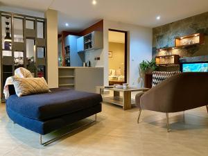 a living room with a chair and a couch at Sunny Suites Madagascar in Antananarivo