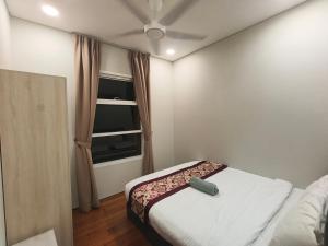 a small bedroom with a bed and a ceiling fan at Klcc vortex runner in Kuala Lumpur