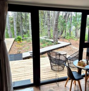 a screened porch with a view of the woods at Bosque Cipreses Sur in San Carlos de Bariloche +57 photos
