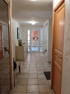 a hallway of a house with a tile floor at Maison du vieux chêne in Grimaud