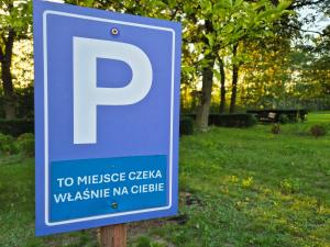 a blue parking sign in front of a park at Uroczysko Porszewice - Ośrodek Rekolekcyjno-Konferencyjny koło Łodzi in Łódź +81 photos