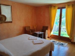 a bedroom with a bed and a large window at Maison du vieux chêne in Grimaud +13 photos