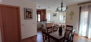 a dining room and living room with a table and chairs at Toledo Magico in Toledo