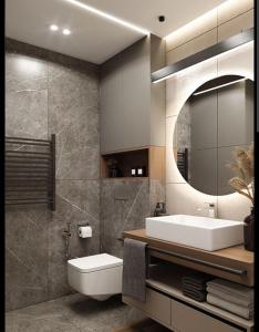 a bathroom with a sink and a toilet and a mirror at Naini reflections in Nainital