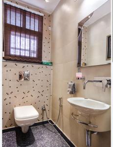 a bathroom with a sink and a toilet at Naini reflections in Nainital +10 photos