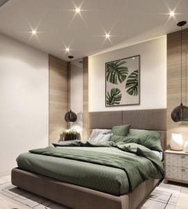 a bedroom with a large green bed in it at Naini reflections in Nainital