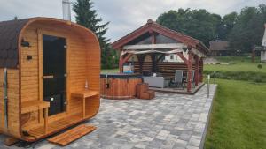 a large wooden gazebo with a gazebo at POD DĘBEM in Cerkiewnik +6 photos