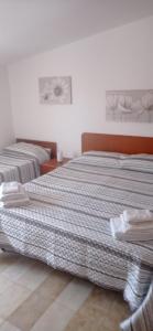 two beds sitting next to each other in a bedroom at Hotel Tania in Casa Giosafat +15 photos