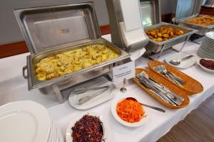 a buffet of food on a table with plates of food at Uroczysko Porszewice - Ośrodek Rekolekcyjno-Konferencyjny koło Łodzi in Łódź