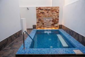 a indoor swimming pool with a brick wall at 2BR-3BA Condo Block from Beach w Rooftop Jacuzzi in Mazatlán