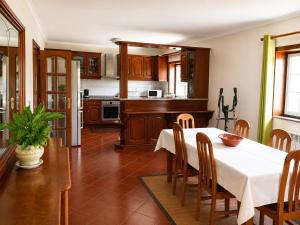 a kitchen and dining room with a table and chairs at Casa Corujeira in Santa