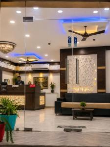 a lobby of a hotel with a man standing in the lobby at Hotel Bed & Room in Agra