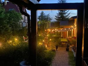 an outside view of a garden with lights at Dom nad Wigrami in Suwałki