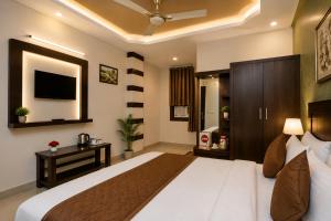 a bedroom with a large bed and a television at Hotel Bed & Room in Agra