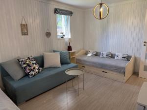 a living room with a couch and a bed at Dom nad Wigrami in Suwałki