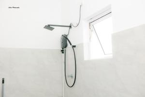 a shower in a bathroom with a window at The Fort House - Matara in Matara +24 photos