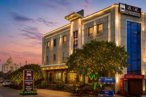 a building on a city street with a building at Hotel Bed & Room in Agra